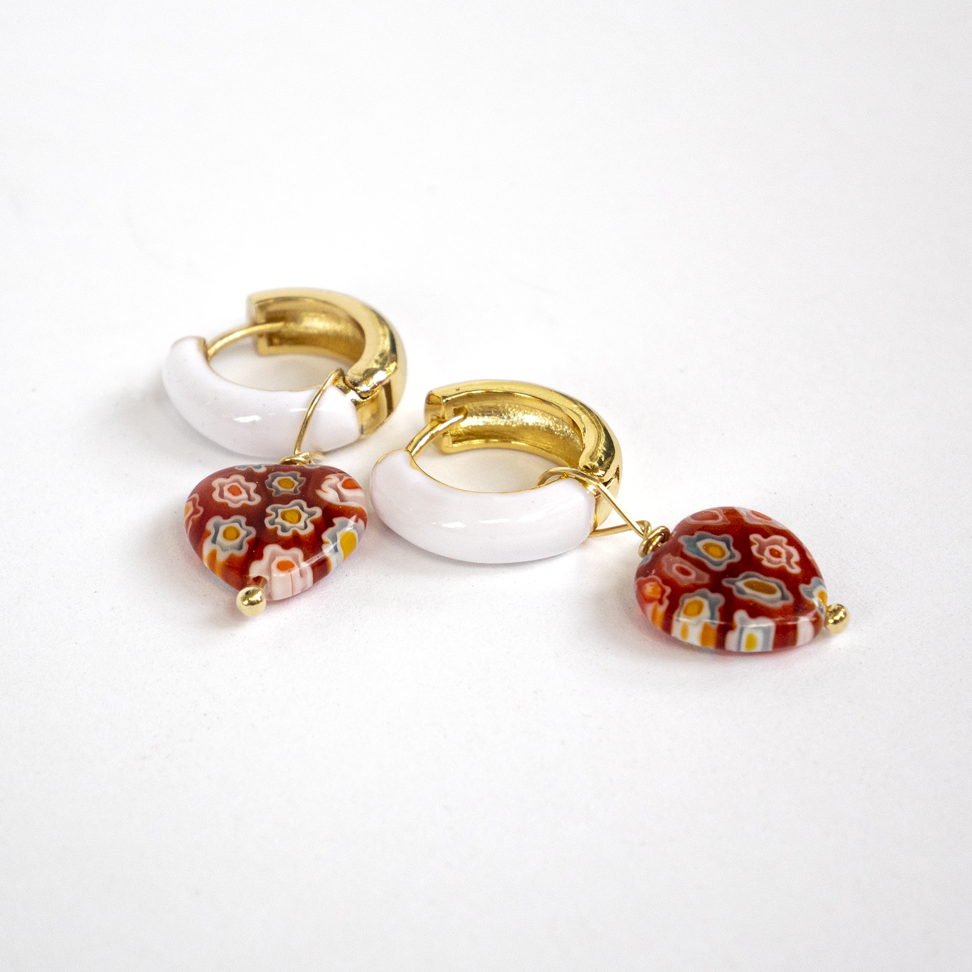 Stainless steal white enamel hoop earrings with orange millefiori heart beads.